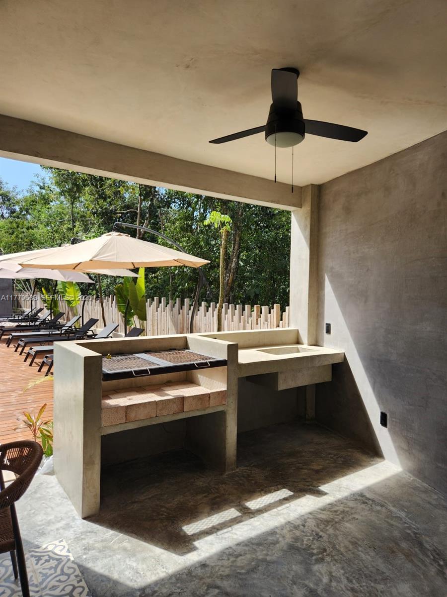 77760 Itzamna, Unit D101 undefined, FL 00000 - Photo 29 of 35 a view of a kitchen with a sink and dishwasher a stove top oven with wooden floor