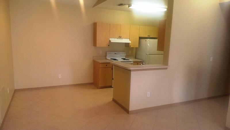 10276 Fox Trail Road South, Unit 111 West Palm Beach, FL 33411 - Photo 8 of 16 a view of a kitchen with a sink and a stove