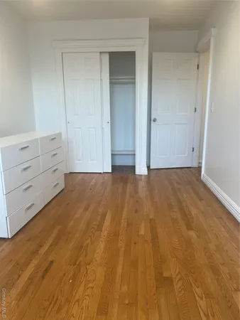 a view of an empty room and wooden floor