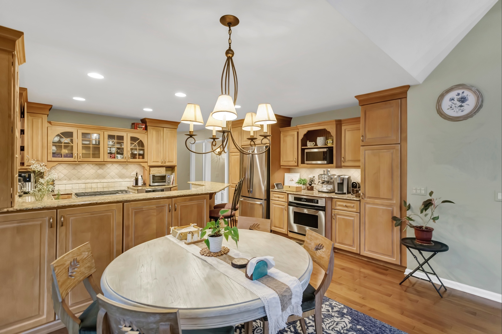 985 Chapel Court North Glen Ellyn, IL 60137 - Photo 14 of 46 a kitchen with a table chairs stove and microwave