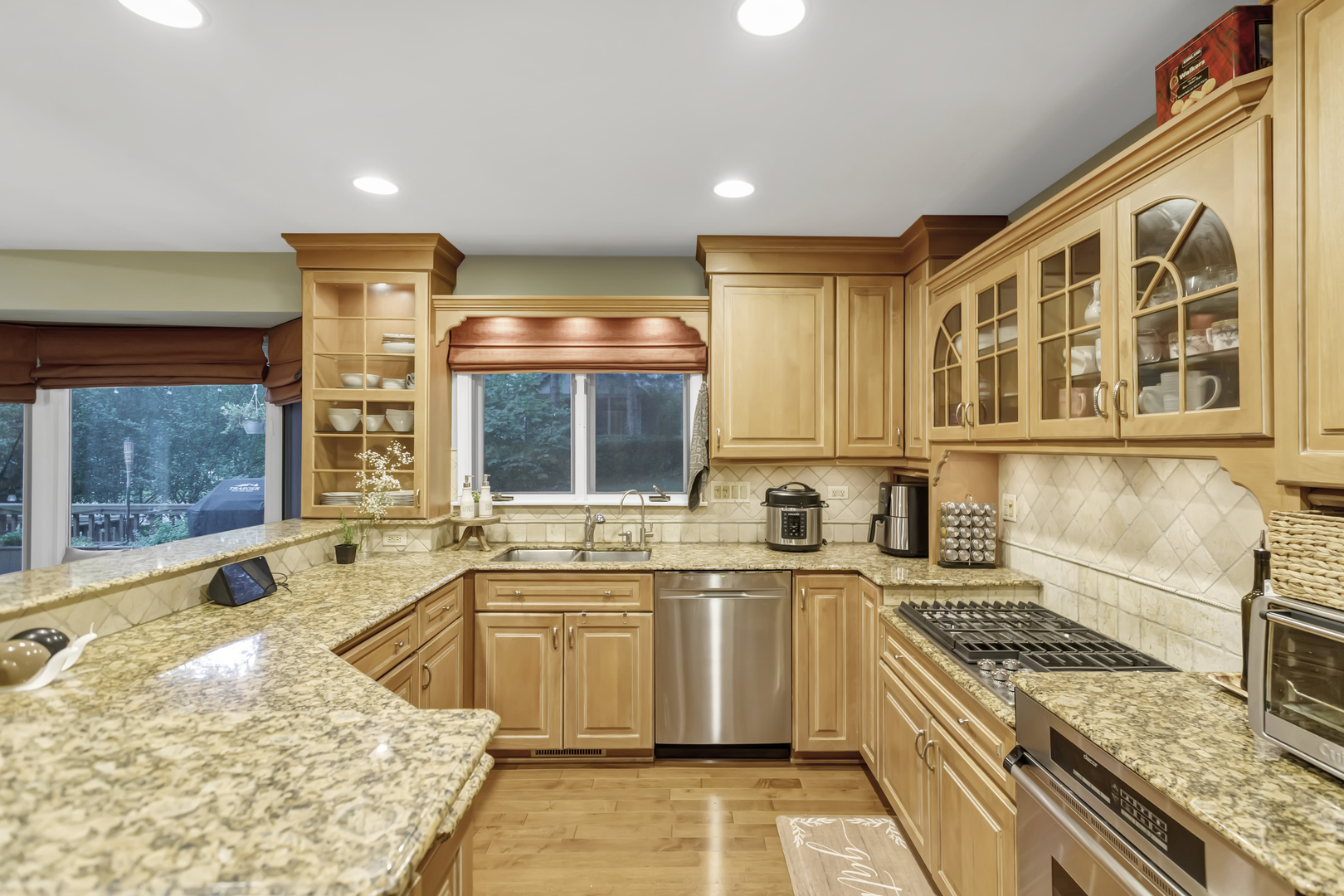 985 Chapel Court North Glen Ellyn, IL 60137 - Photo 15 of 46 a large kitchen with stainless steel appliances granite countertop a sink and a stove