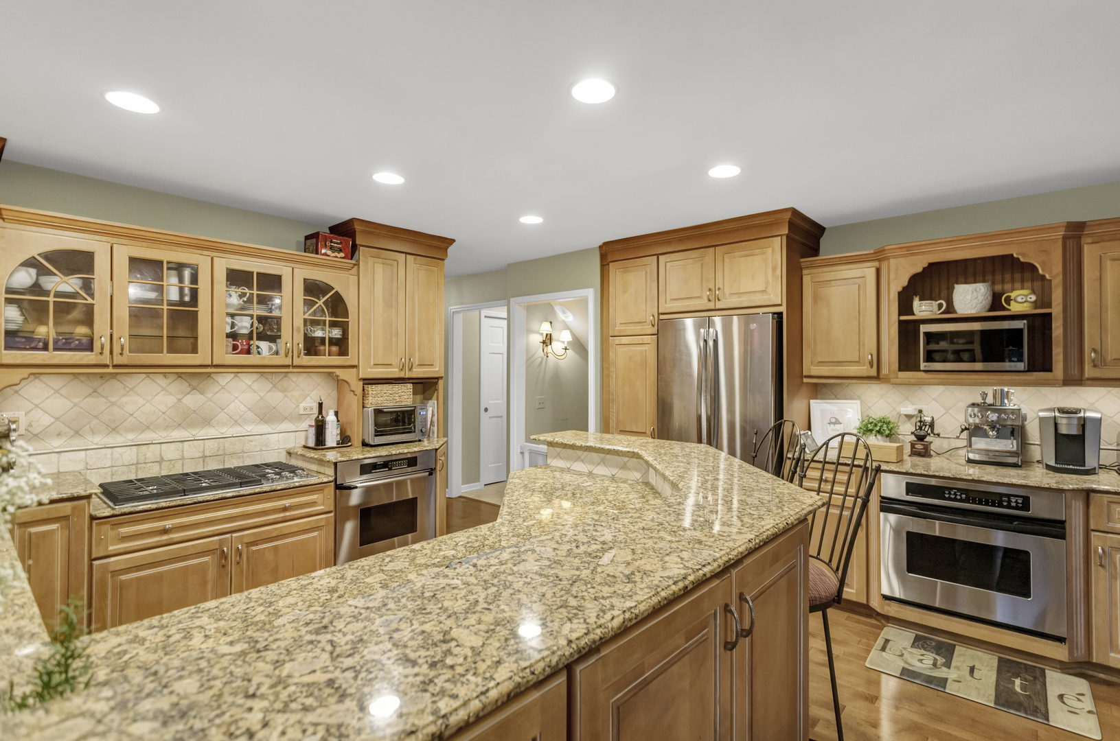 985 Chapel Court North Glen Ellyn, IL 60137 - Photo 17 of 46 a kitchen with stainless steel appliances a stove a sink and a refrigerator