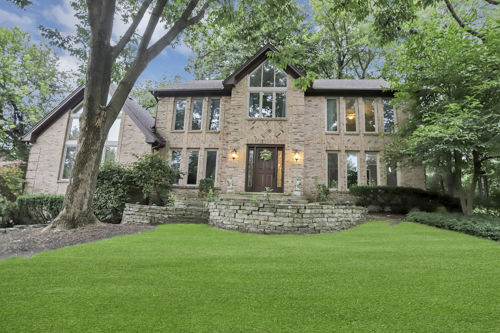 985 Chapel Court North Glen Ellyn, IL 60137 - Photo 3 of 46 a front view of a house with a garden and trees