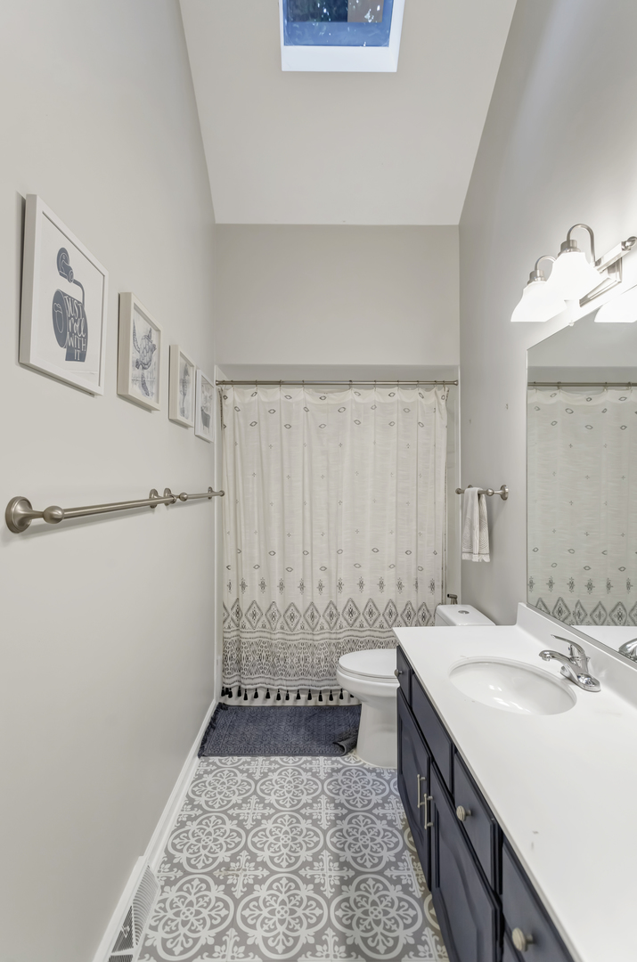 985 Chapel Court North Glen Ellyn, IL 60137 - Photo 32 of 46 a bathroom with a sink and a mirror