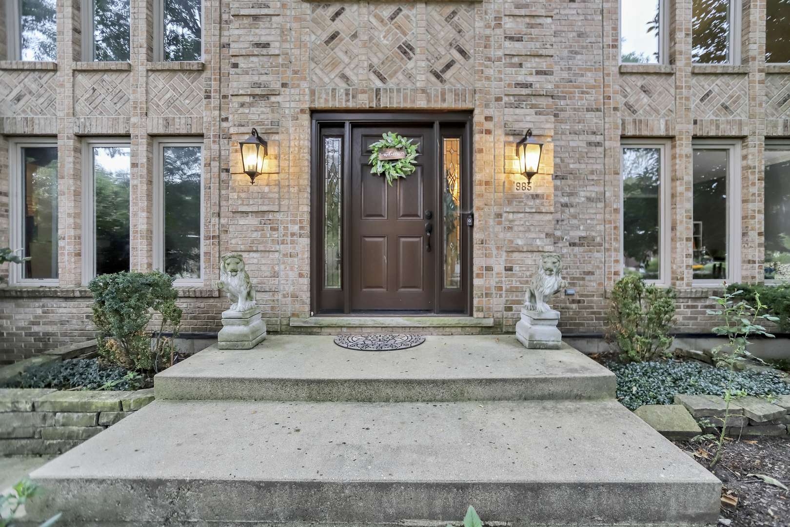 985 Chapel Court North Glen Ellyn, IL 60137 - Photo 4 of 46 a front view of a brick house with a rug