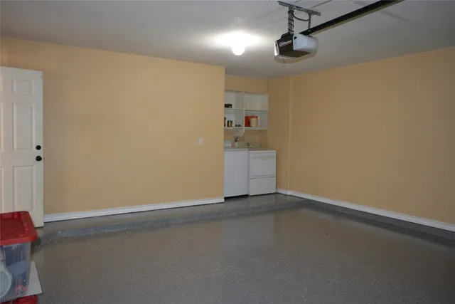 an empty room with chandelier fan