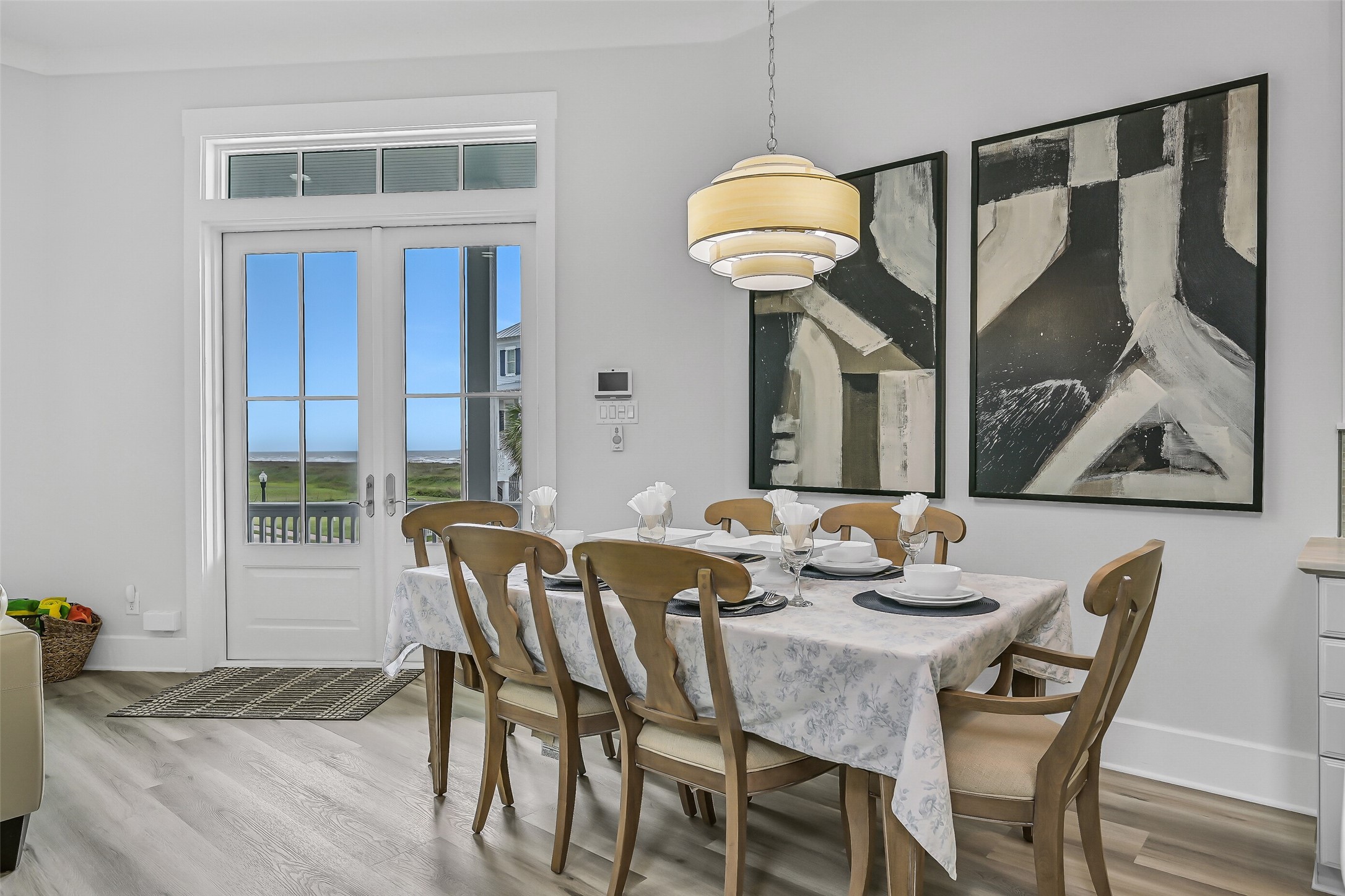 817 Positano Road Galveston, TX 77550 - Photo 19 of 50 Enjoy dinner with a hint of Gulf views just beyond the doors. Framed by updated interiors and a bright coastal ambiance, this dining space creates an inviting setting for everything from casual breakfasts to special celebrations.