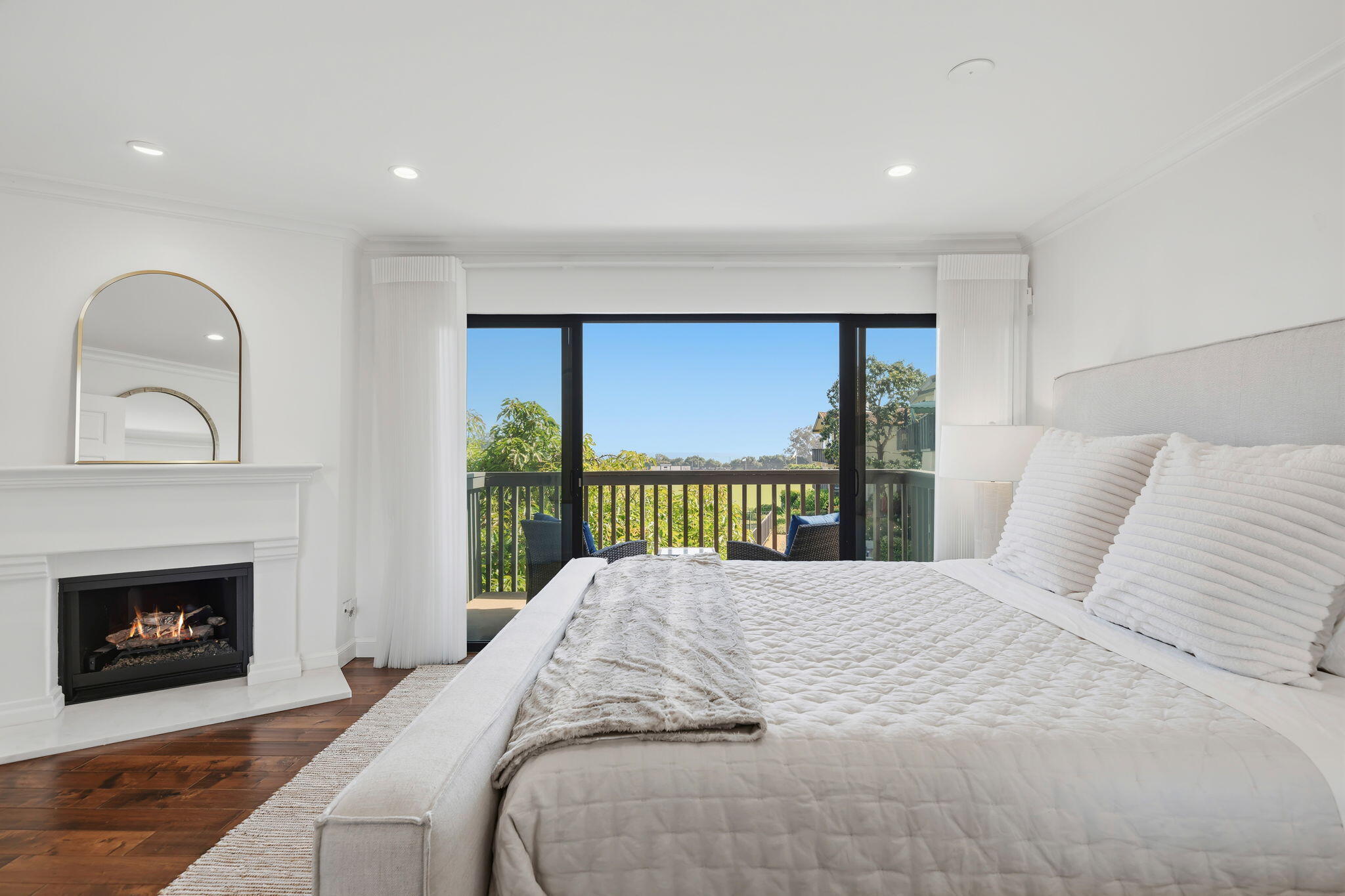 3375 Foothill Road, Unit 722 Carpinteria, CA 93013 - Photo 17 of 33 a bedroom with a bed and a fireplace