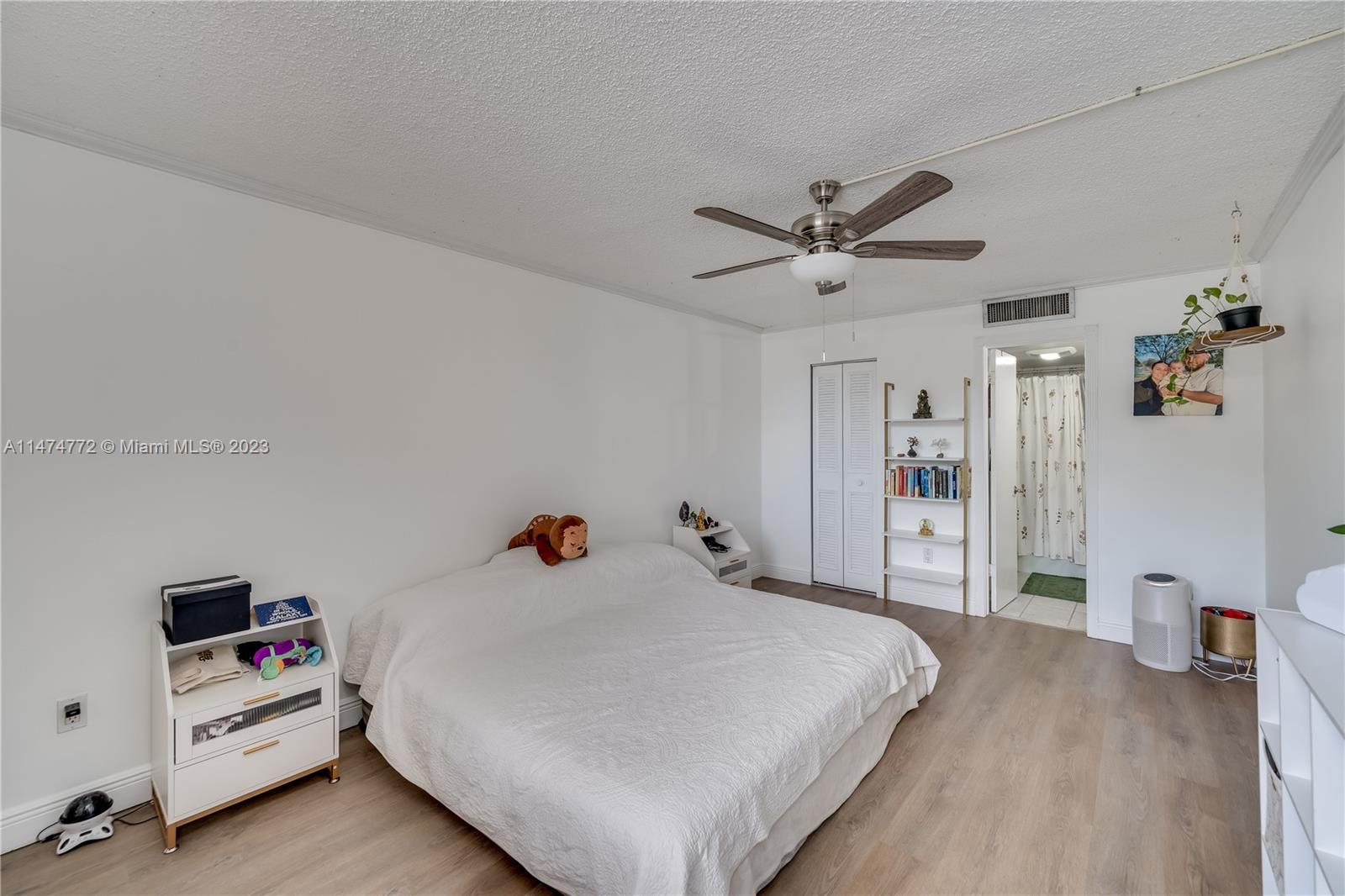 Promenade at Kendale Lakes Condominiums Miami, FL 33186 - Photo 12 of 29 a bed room with a bed and a chandelier