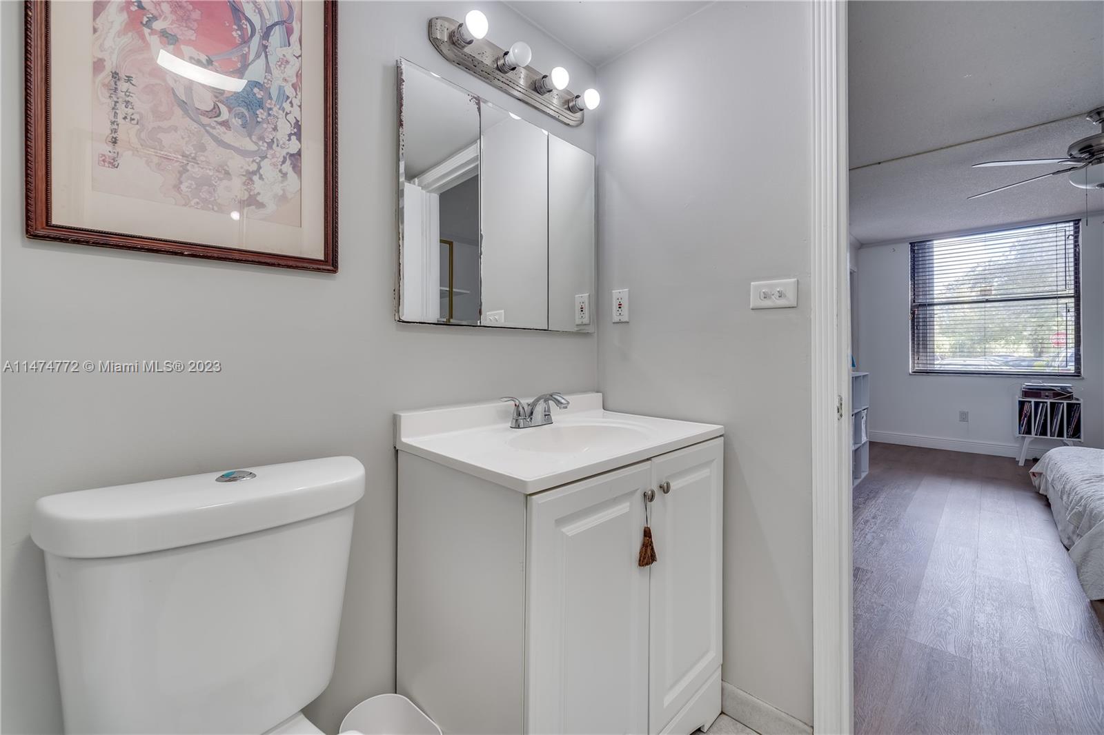 Promenade at Kendale Lakes Condominiums Miami, FL 33186 - Photo 15 of 29 a bathroom with a toilet sink and mirror