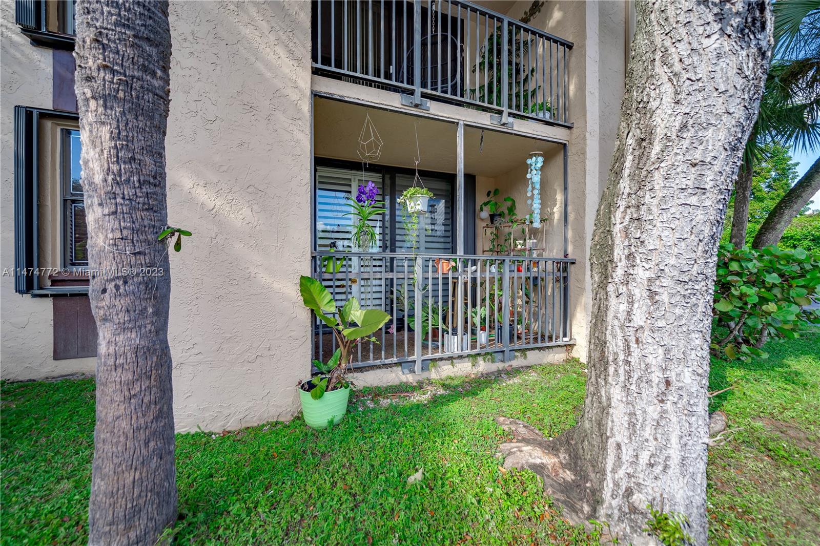 Promenade at Kendale Lakes Condominiums Miami, FL 33186 - Photo 26 of 29 front view of a house with a yard balcony