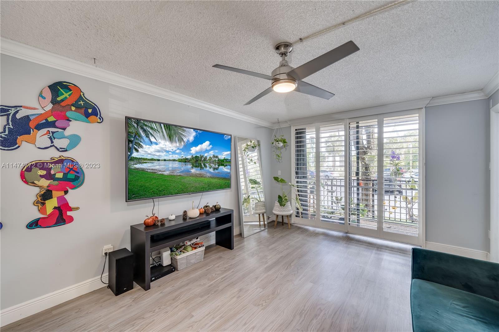 Promenade at Kendale Lakes Condominiums Miami, FL 33186 - Photo 7 of 29 a living room with furniture and a flat screen tv