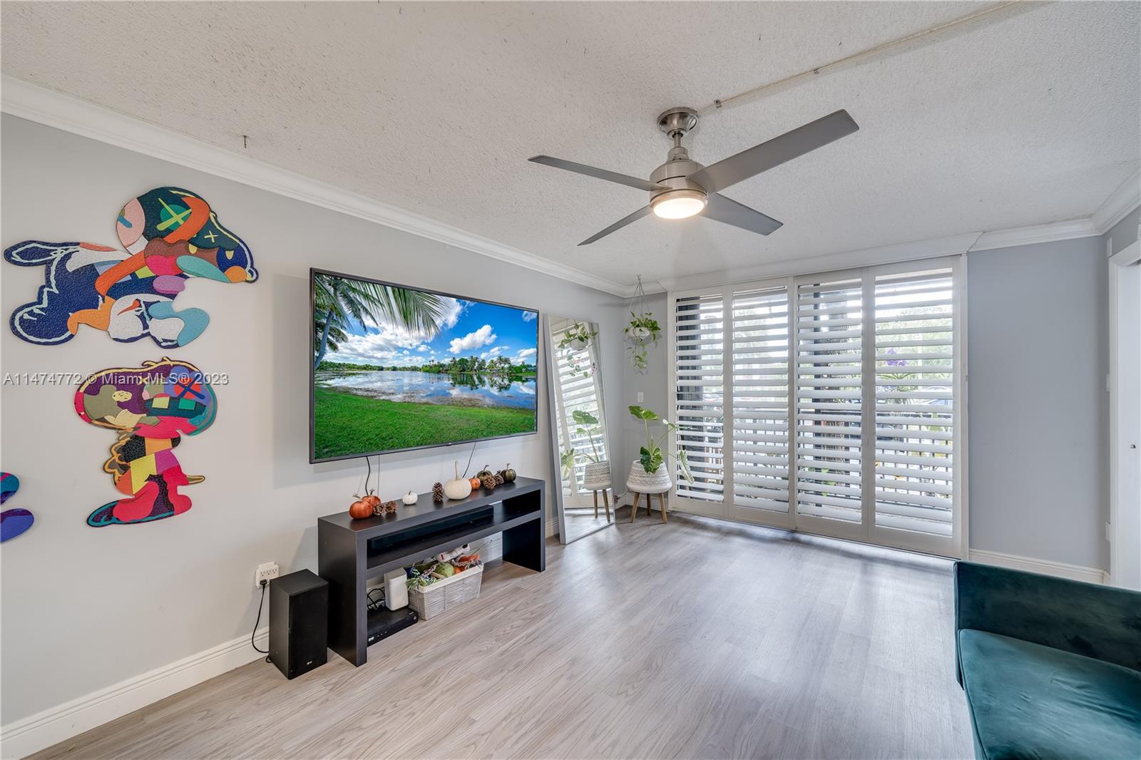 Promenade at Kendale Lakes Condominiums Miami, FL 33186 - Photo 8 of 29 a living room with furniture and a flat screen tv