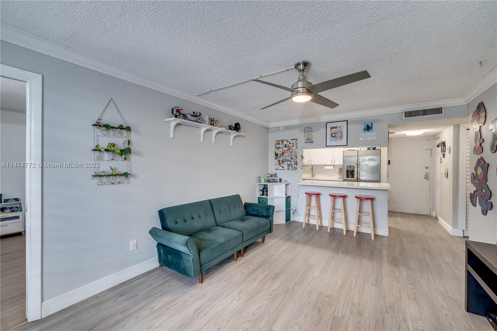 Promenade at Kendale Lakes Condominiums Miami, FL 33186 - Photo 10 of 29 a living room with kitchen island furniture and a kitchen view
