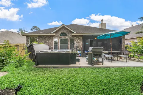 a view of a house with patio and a garden