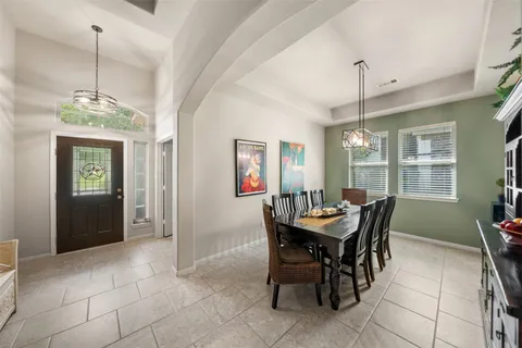a view of a dining room with furniture one side kitchen view and a window