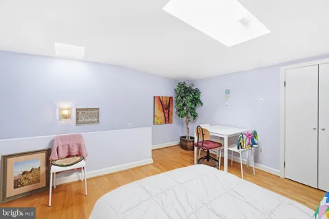 a bedroom with a bed and a chair