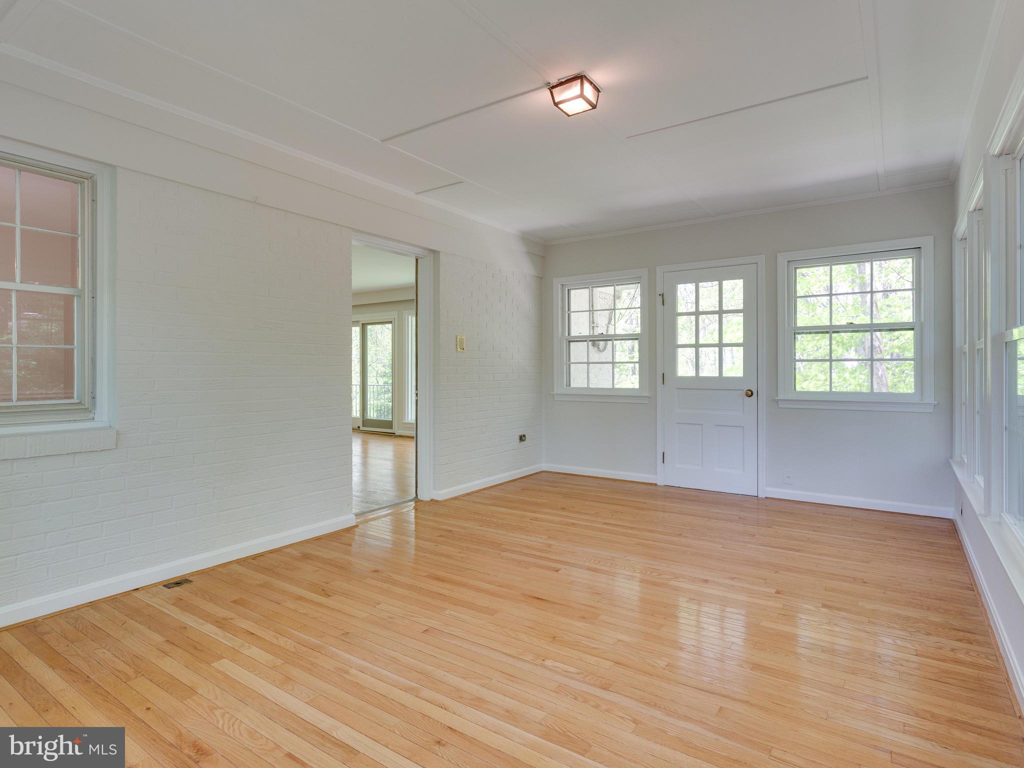 7828 Langley Ridge Road McLean, VA 22102 - Photo 13 of 28 Wood Floors in Sunroom with Entrance to Backyard
