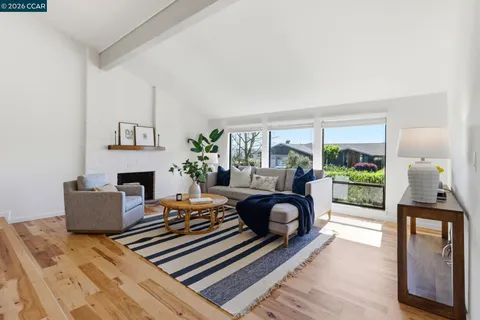 a kitchen with stainless steel appliances granite countertop a stove a sink and a dining table view