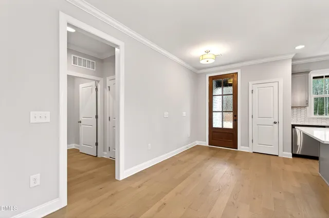 a kitchen with a sink a stove a refrigerator and a window