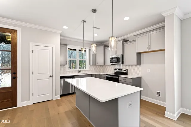 a kitchen with a sink stove and cabinets