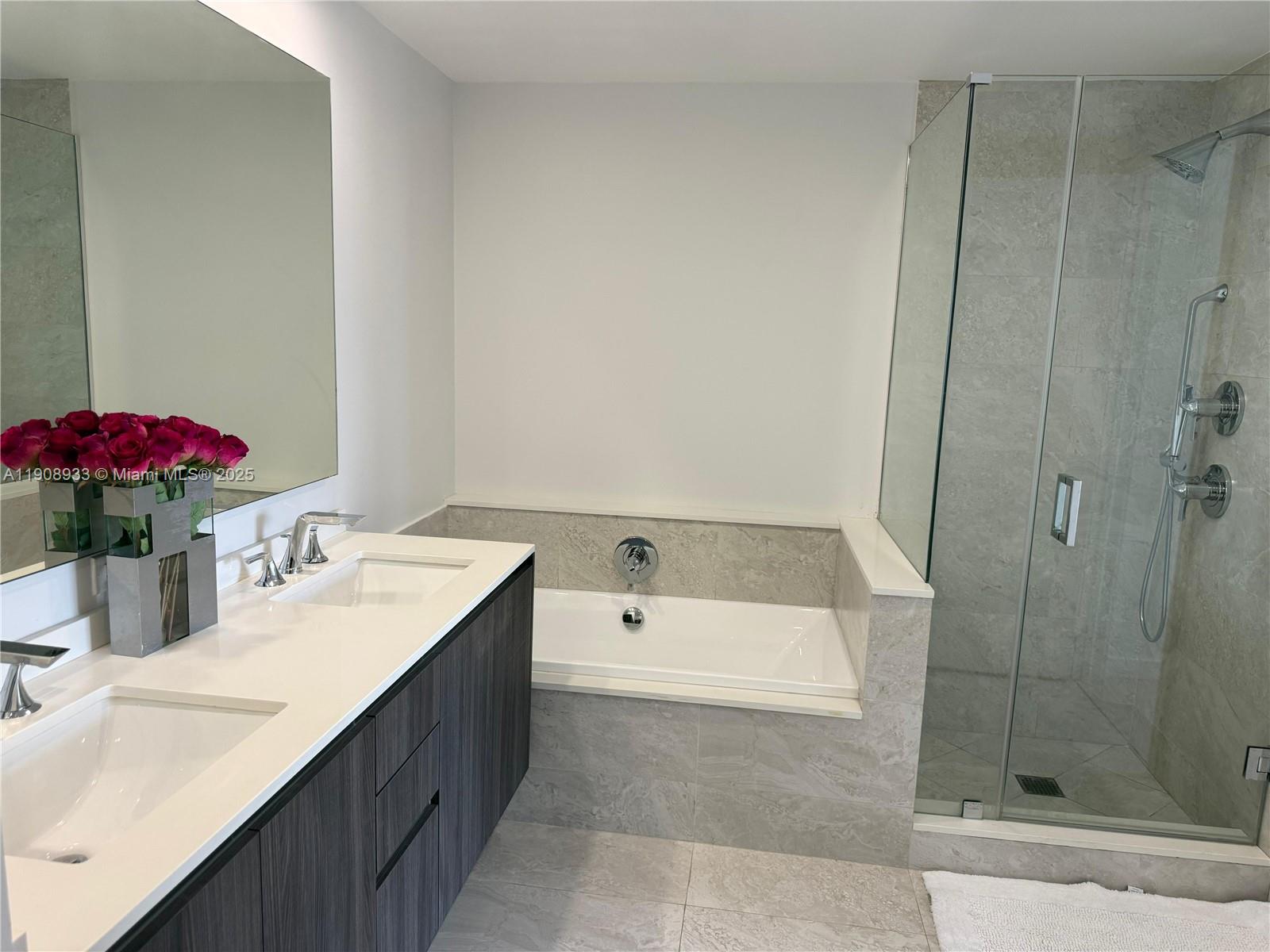 488 Northeast 18th Street, Unit 2701 Miami, FL 33132 - Photo 12 of 70 a bathroom with a tub sink and mirror
