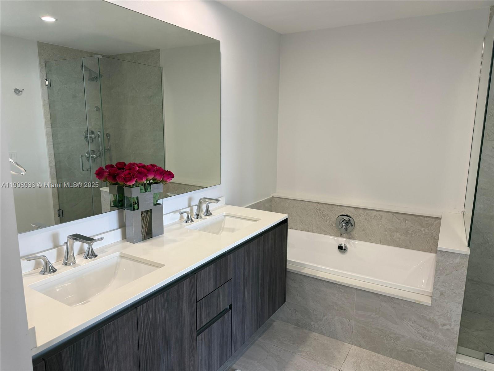 488 Northeast 18th Street, Unit 2701 Miami, FL 33132 - Photo 13 of 70 a bathroom with a sink and a mirror