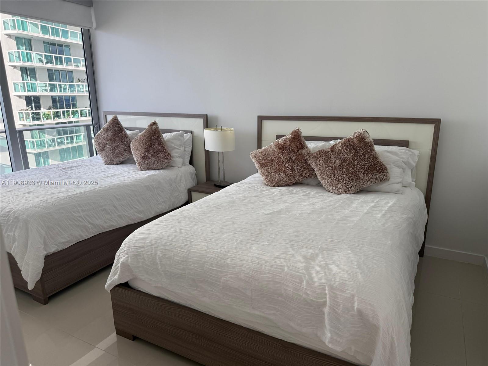 488 Northeast 18th Street, Unit 2701 Miami, FL 33132 - Photo 15 of 70 a bedroom with double bed and a large window