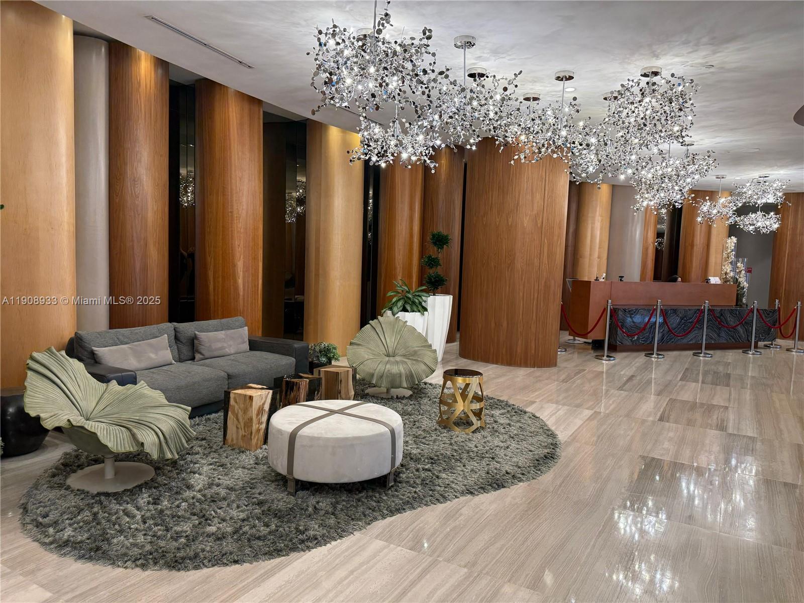 488 Northeast 18th Street, Unit 2701 Miami, FL 33132 - Photo 18 of 70 a living room with furniture and a chandelier