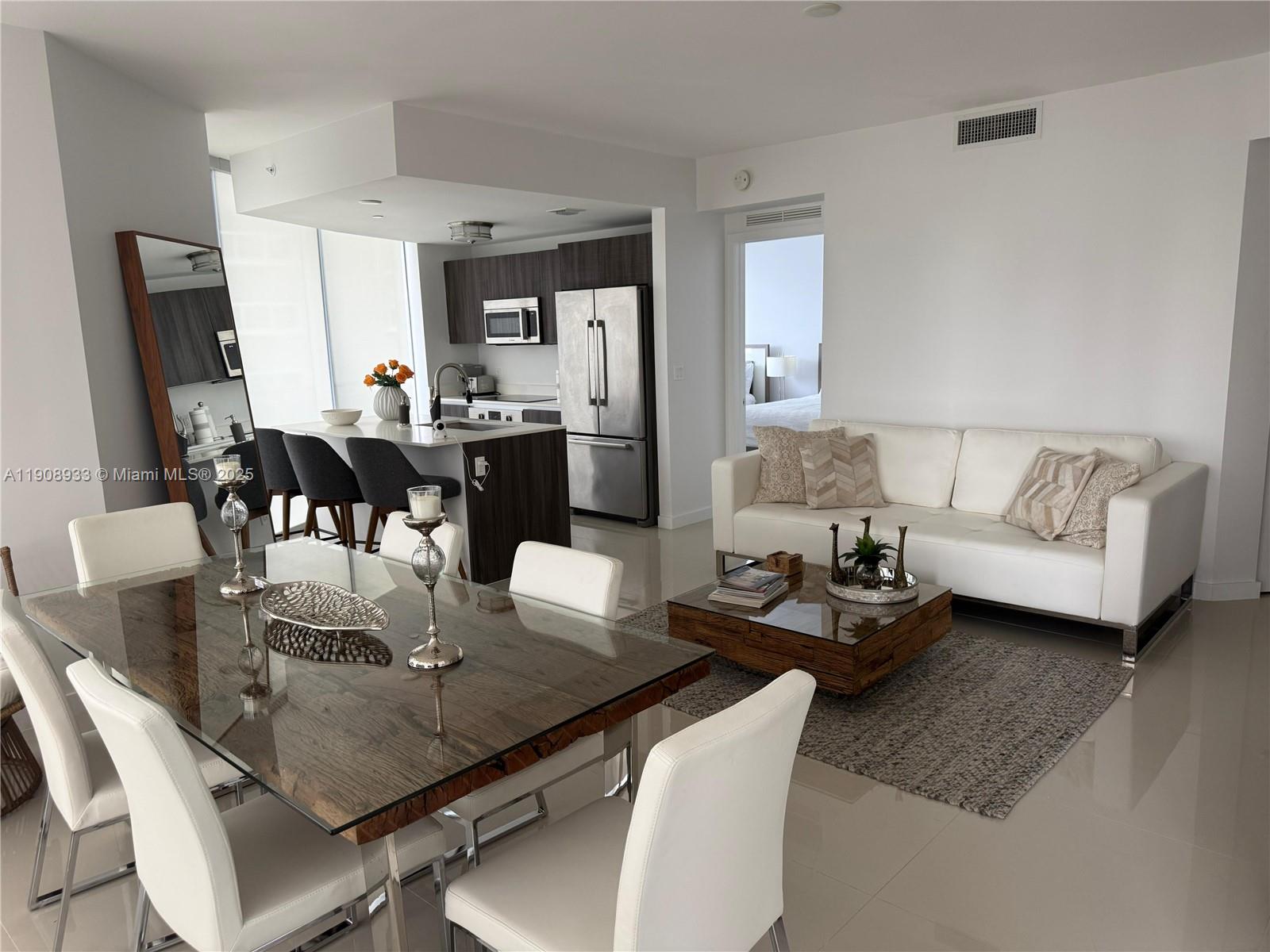 488 Northeast 18th Street, Unit 2701 Miami, FL 33132 - Photo 3 of 70 a living room with furniture and wooden floor