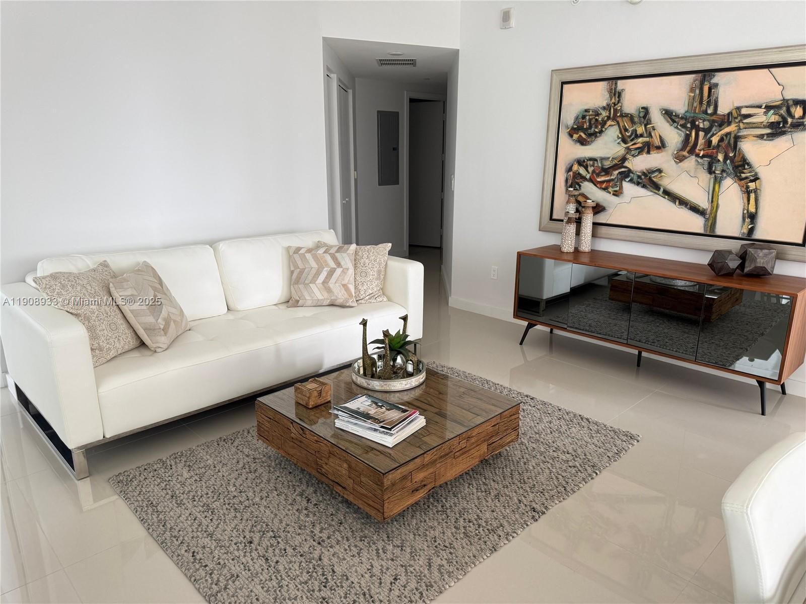 488 Northeast 18th Street, Unit 2701 Miami, FL 33132 - Photo 8 of 70 a living room with furniture and a rug