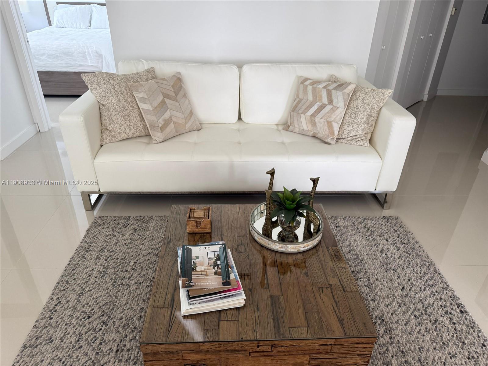 488 Northeast 18th Street, Unit 2701 Miami, FL 33132 - Photo 9 of 70 a living room with furniture and a rug