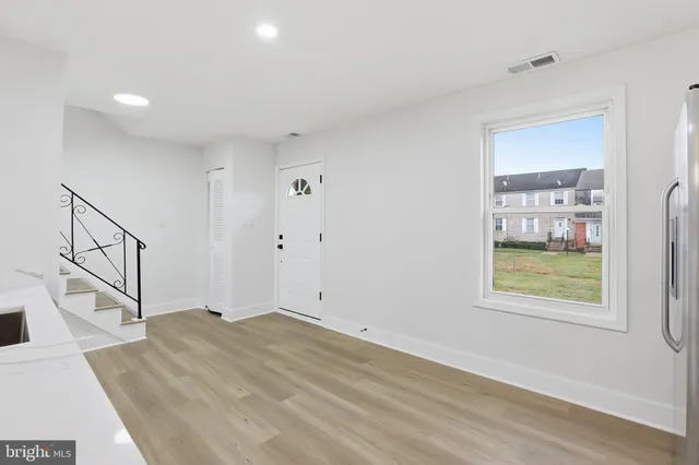 a large kitchen with cabinets stainless steel appliances and a counter space