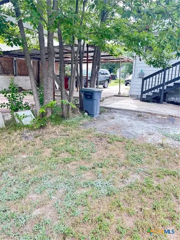 a view of a back yard with a swing
