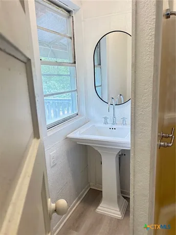 a bathroom with a sink and a mirror