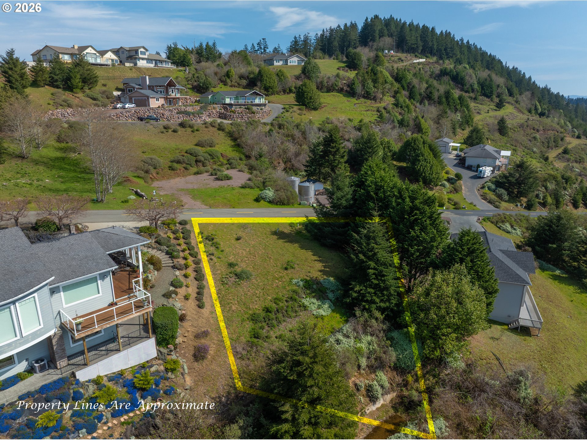 98010 Crown Terrace, Unit 1 Brookings, OR 97415 - Photo 7 of 10 an aerial view of residential houses with outdoor space and trees