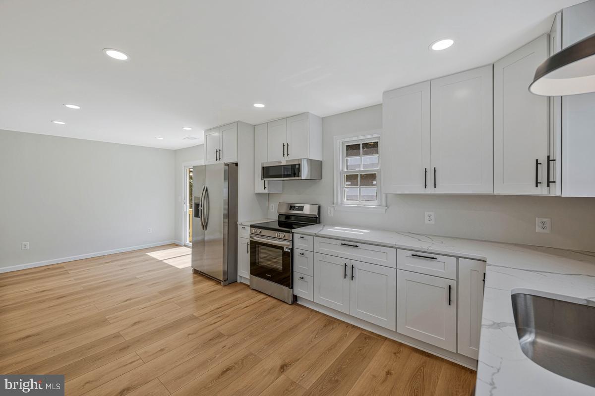13304 Cherry Tree Crossing Road Brandywine, MD 20613 - Photo 28 of 32 Modern kitchen with sleek finishes.