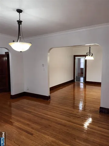 a view of a room with wooden floor