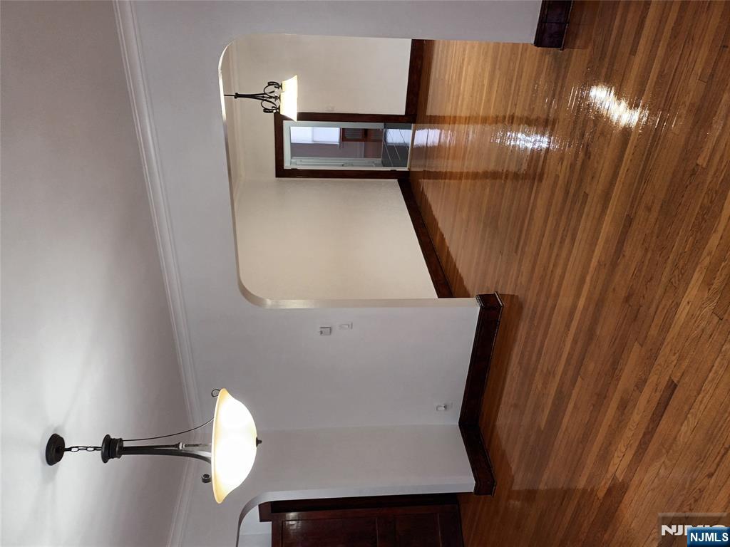 a view of a room with wooden floor