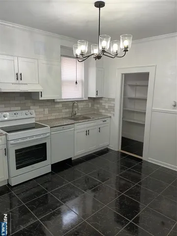 a open kitchen with a sink and stove top oven