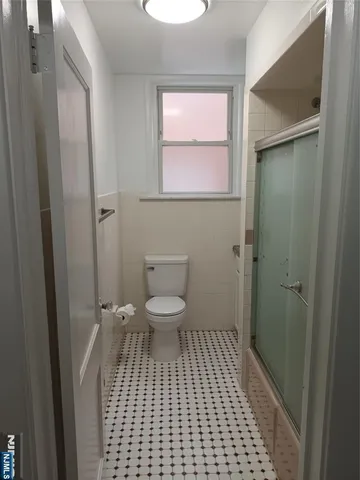a bathroom with a toilet a sink and a shower