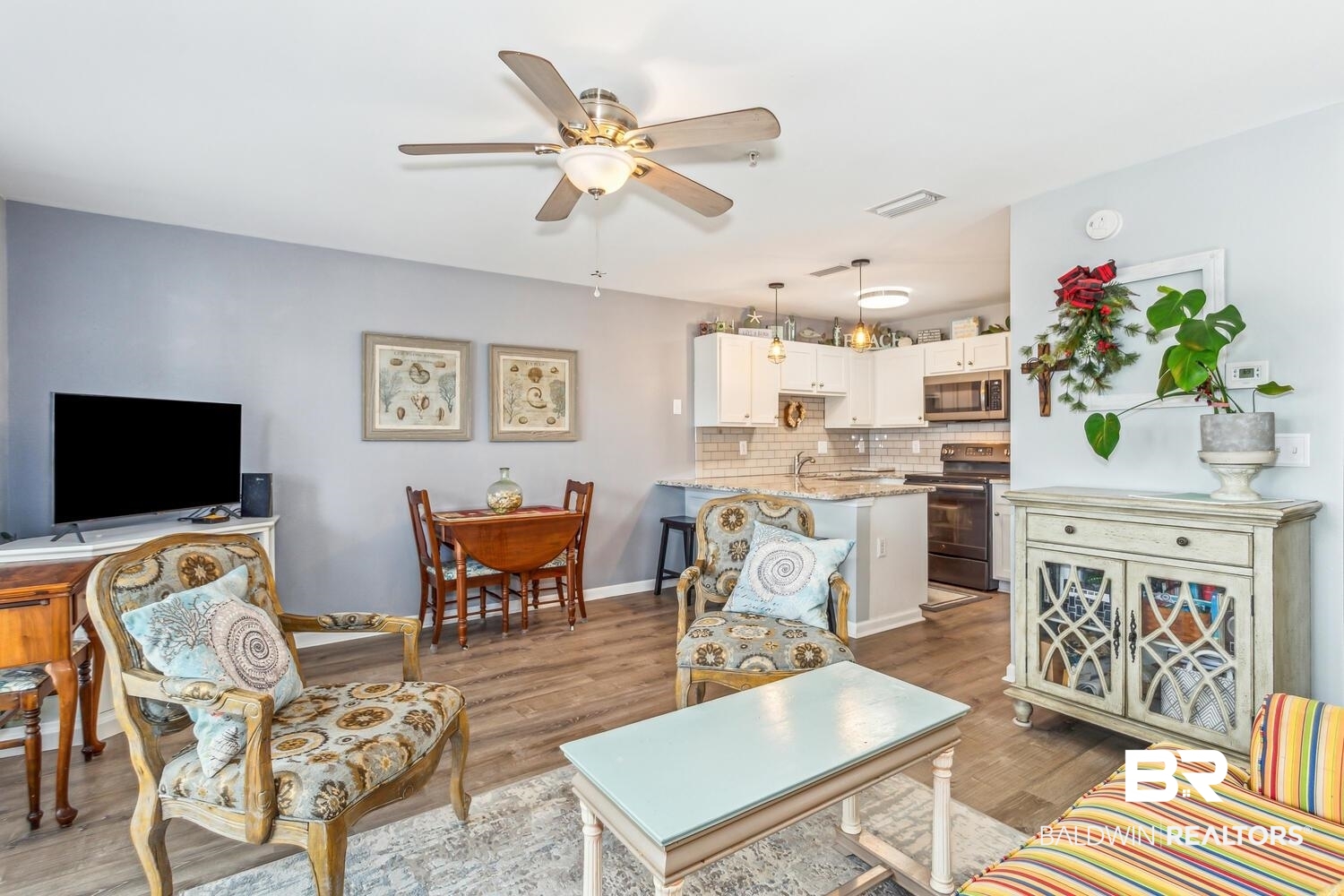 13551 Johnson Beach Road, Unit 112E Pensacola, FL 32507 - Photo 9 of 42 Living room with ceiling fan, sink, and hardwood / wood-style floors