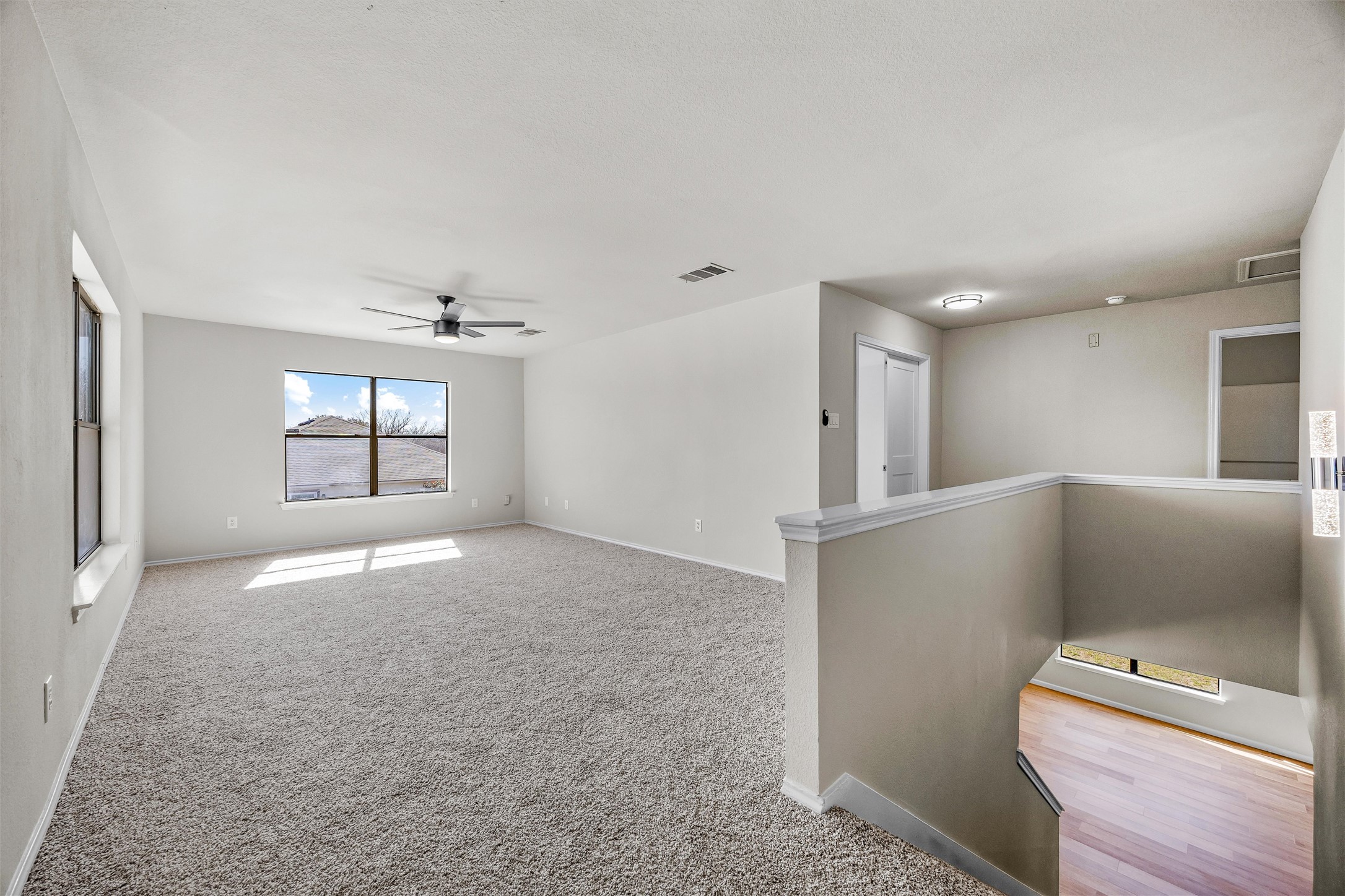 7541 Redrick Drive Austin, TX 78747 - Photo 25 of 40 Carpeted empty room featuring a ceiling fan, baseboards, and visible vents
