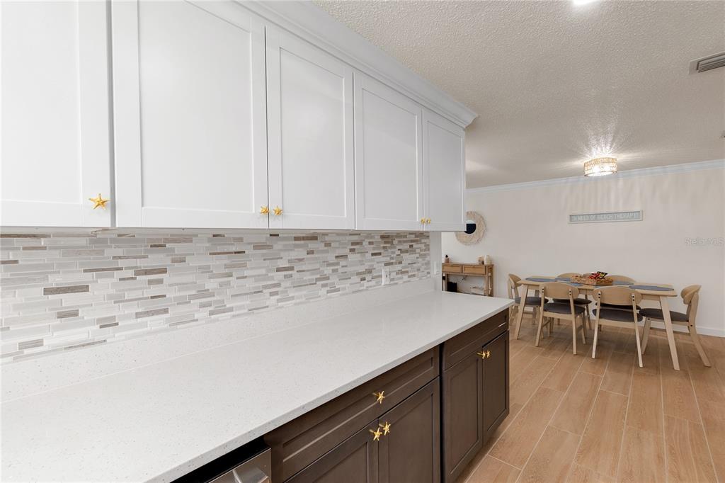 407 63rd Street Holmes Beach, FL 34217 - Photo 12 of 33 a kitchen with a table and chairs in it