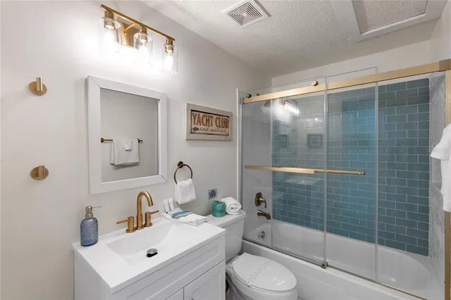 a bathroom with a sink mirror toilet and bathtub