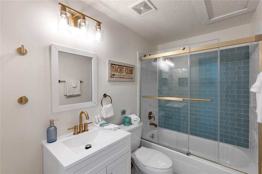 407 63rd Street Holmes Beach, FL 34217 - Photo 13 of 33 a bathroom with a sink toilet and shower