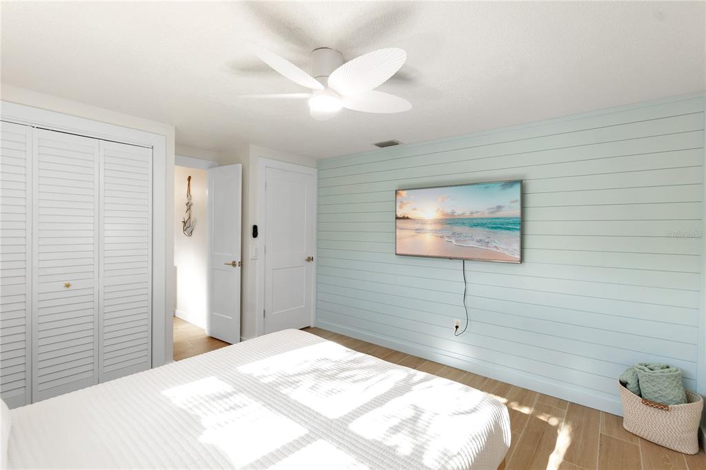 407 63rd Street Holmes Beach, FL 34217 - Photo 15 of 33 a bedroom with a bed and a chandelier