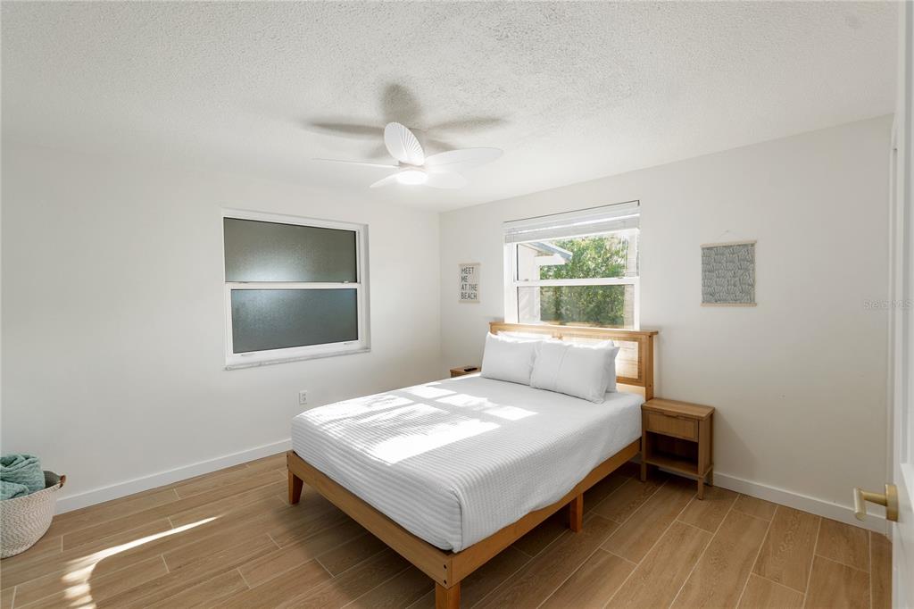 407 63rd Street Holmes Beach, FL 34217 - Photo 16 of 33 a bedroom with a bed and a window