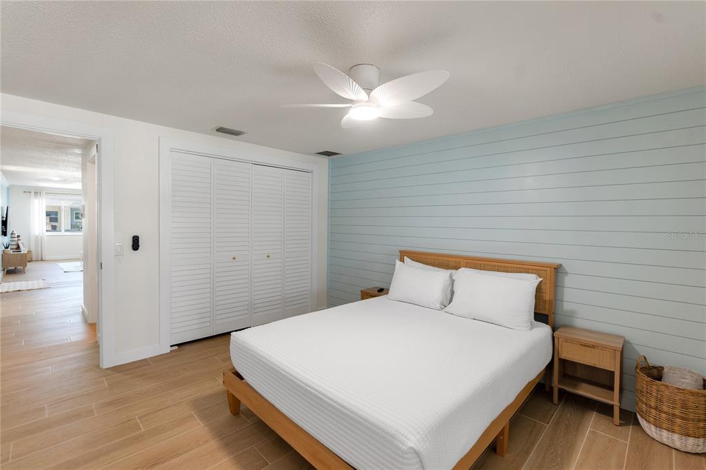 407 63rd Street Holmes Beach, FL 34217 - Photo 18 of 33 a bedroom with a bed and wooden floor