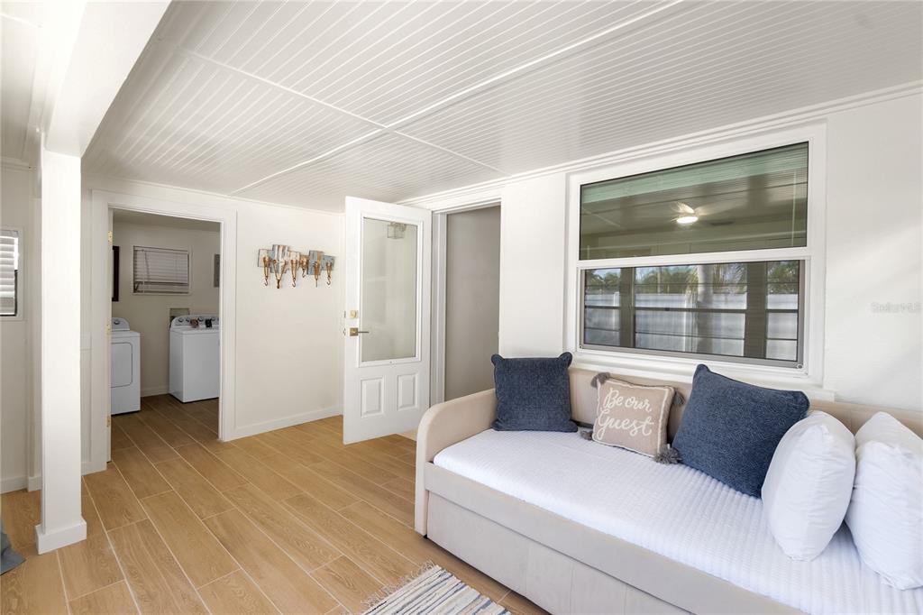 407 63rd Street Holmes Beach, FL 34217 - Photo 21 of 33 a living room with furniture and a large window